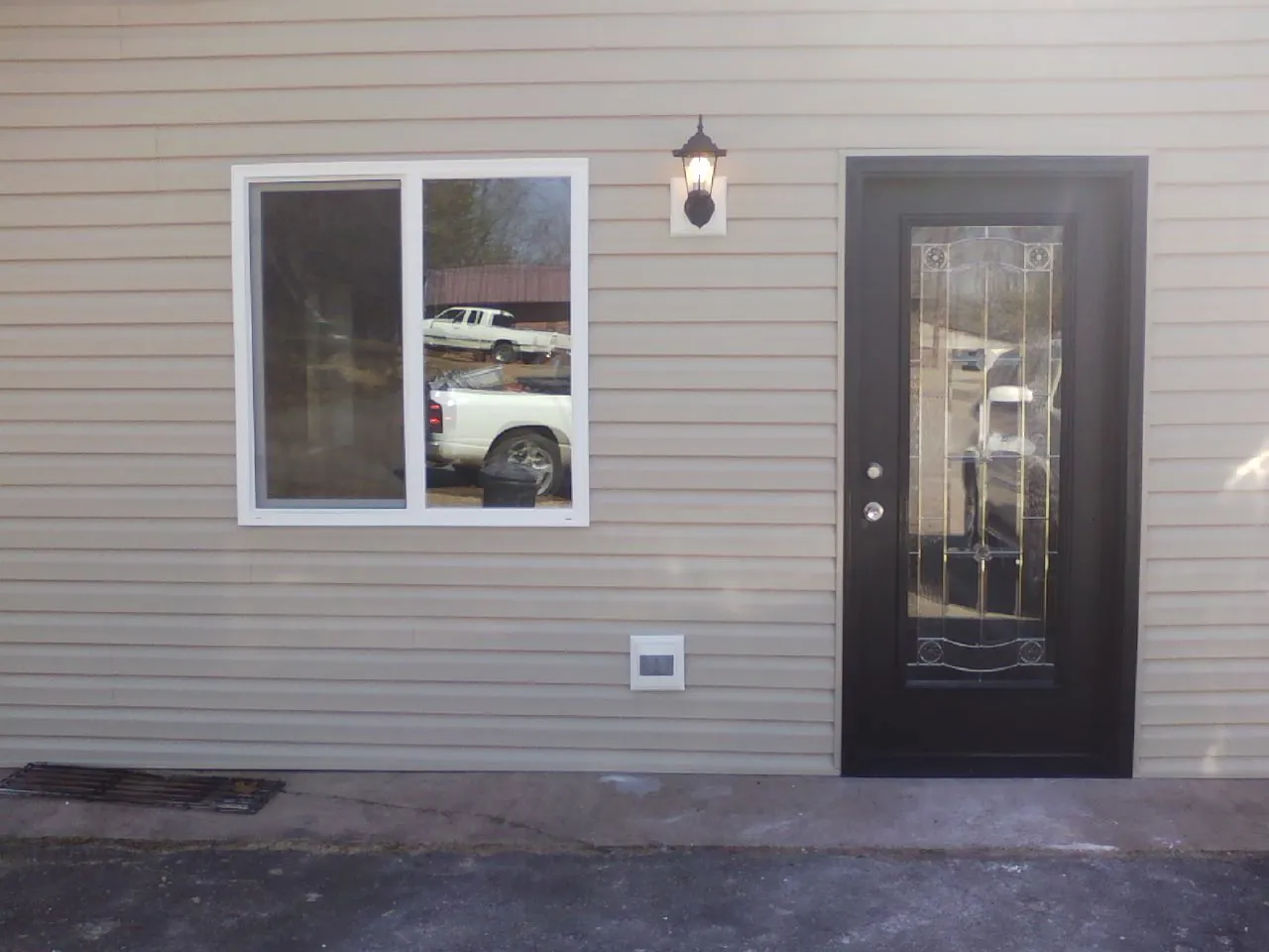 New siding, window and entry door on the side of an addition in Chester